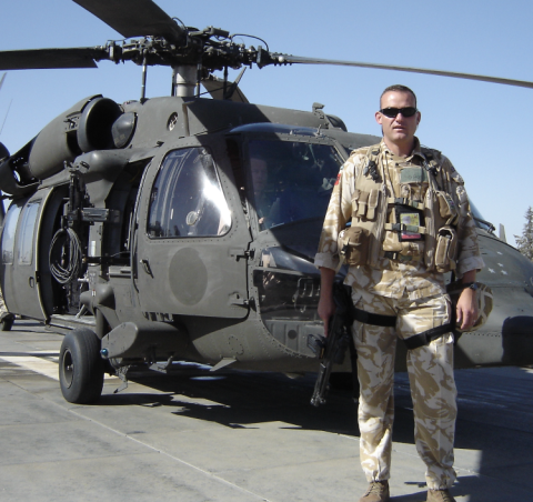 OS Andrew Connelly standing by a military helicopter