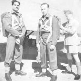 Jock Grimmond having parachute fitted. Mohn Kahn watching. Rawalpindi 1944