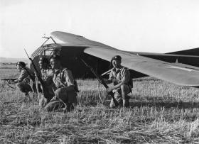 Men of the Border Regiment pose in front of a WACO glider during Exercise Eve. June 1943.