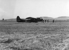 Men move off from their WACO glider after landing during Exercise Eve. June 1943.