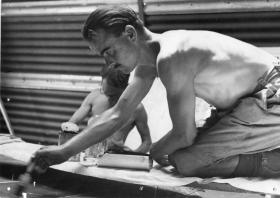 1st Airborne Division artist painting a planning board for a forthcoming operation. 