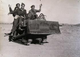 Men of the 2nd Independent Parachute brigade pose for a photo atop an airborne bulldozer at Megara airfield. Greece 1944. 