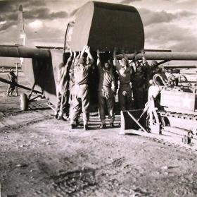 A Clark CA-1 airborne bulldozer being loaded onto a WACO glider.