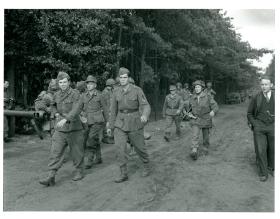 German POWs being brought in by Sgt. Stevie Smith of Divisional HQ. 