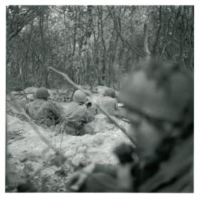 Men of HQ Company, 1st Bn, The Border Regiment, defending the gardens of Van Lennepweg, Oosterbeek.