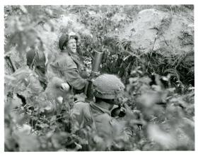 A 3" mortar team in action from No 23 Mortar Platoon (Handcarts), 1st Battalion, The Border Regiment. 