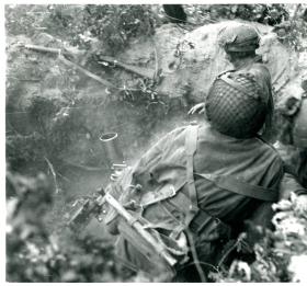 A 3" mortar team in action from No 23 Mortar Platoon (Handcarts), 1st Battalion, The Border Regiment. 