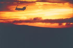 A Chinook silhouetted in the evening sunset, Falklands 1982.