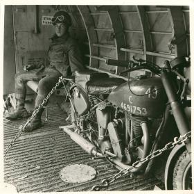 Member of 249 Field Company RE in glider with airborne motorcycle.