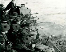 Troops train for the Bruneval raid by firing Bren guns and Boys from a landing craft, 1942.