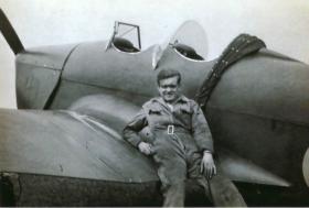 Len Green, Ground Engineer RAFVR, leaning on a Miles Magister used to train glider pilots at No 16 EFTS Burnaston.