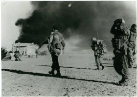 Colonel Paul Crook and Tactical Headquarters walk towards El Gamil airfield's control tower after dropping.