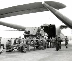Artillery piece being loaded onto a C119 at RAF Boscombe Down, 1950.