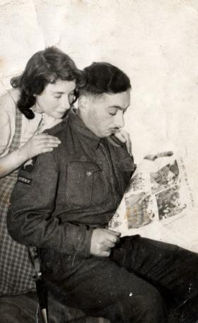 Private Mark Ginsberg reads newspaper coverage of the Bruneval raid.