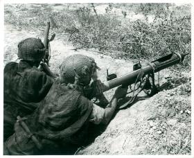 Two paratroopers use a PIAT.