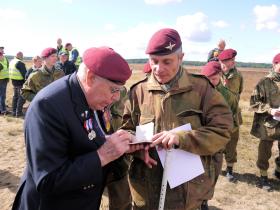 (S/Sgt) Harold Padfield signs a parachute log book, Ginkelse Heide, 22 September 2012.