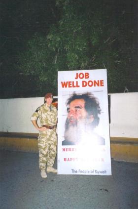 Para pictured with a sign recognising the capture of Saddam Hussein, Kuwait, 2003