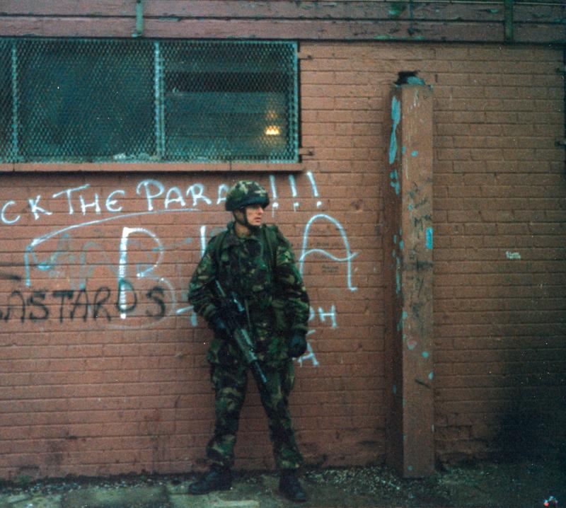 OS Para poses against Nationalist graffiti