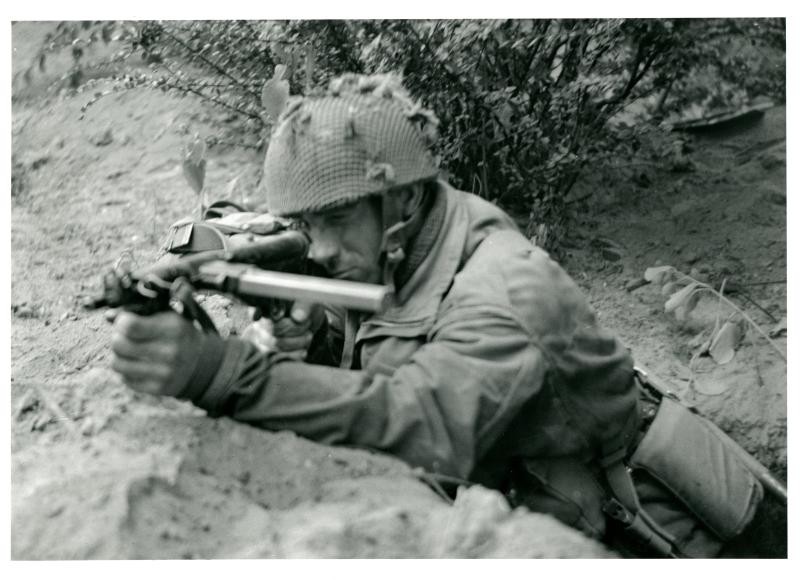 Private Joe Cunnington takes aim with his Mk V Sten Gun. 