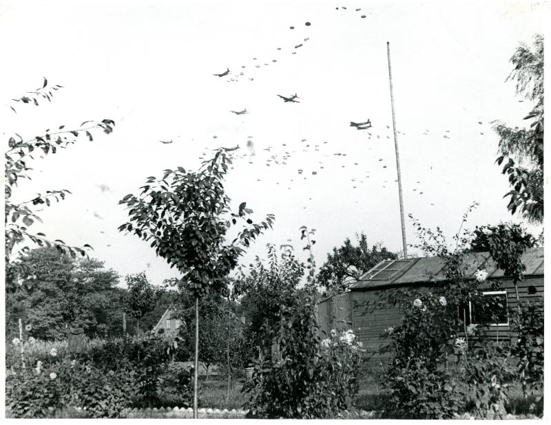 Four-engined Stirlings dropping supplies by parachute to Airborne Forces.