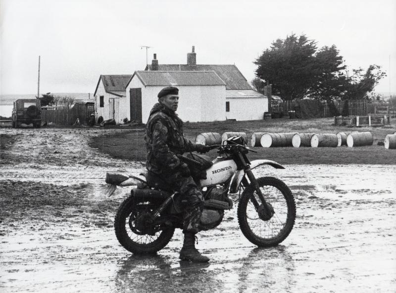 OS RSM Simpson on a locals motorbike, Goose Green. 29 May 1982