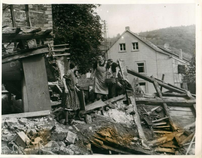German women search the wreckage of their homes shelled by the Americans.
